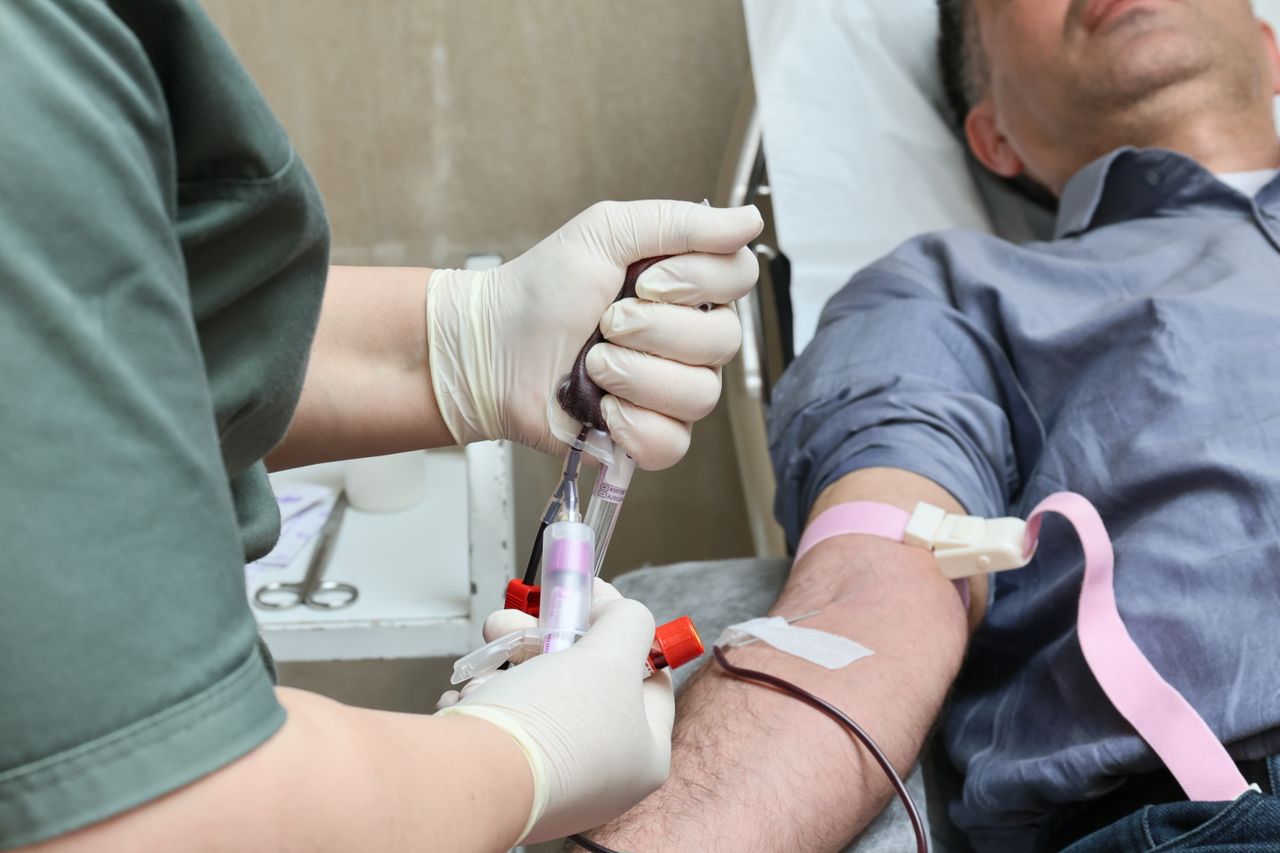 Services A healthcare professional drawing blood from a donor’s arm using a syringe.